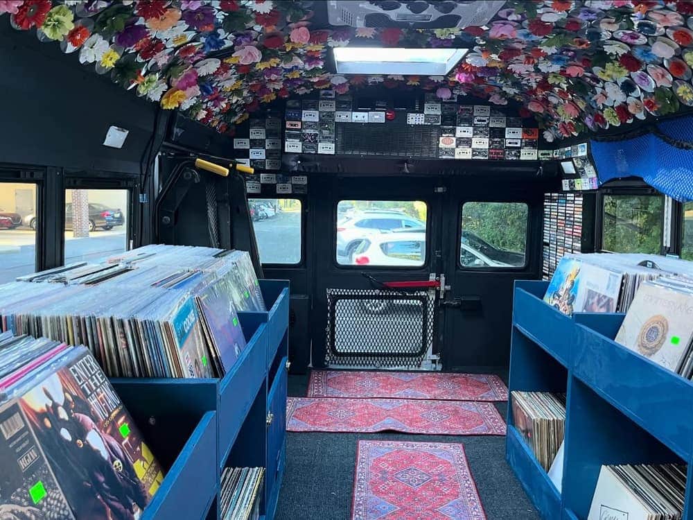 The inside of the Rainbow Record Bus, lined with bins of records